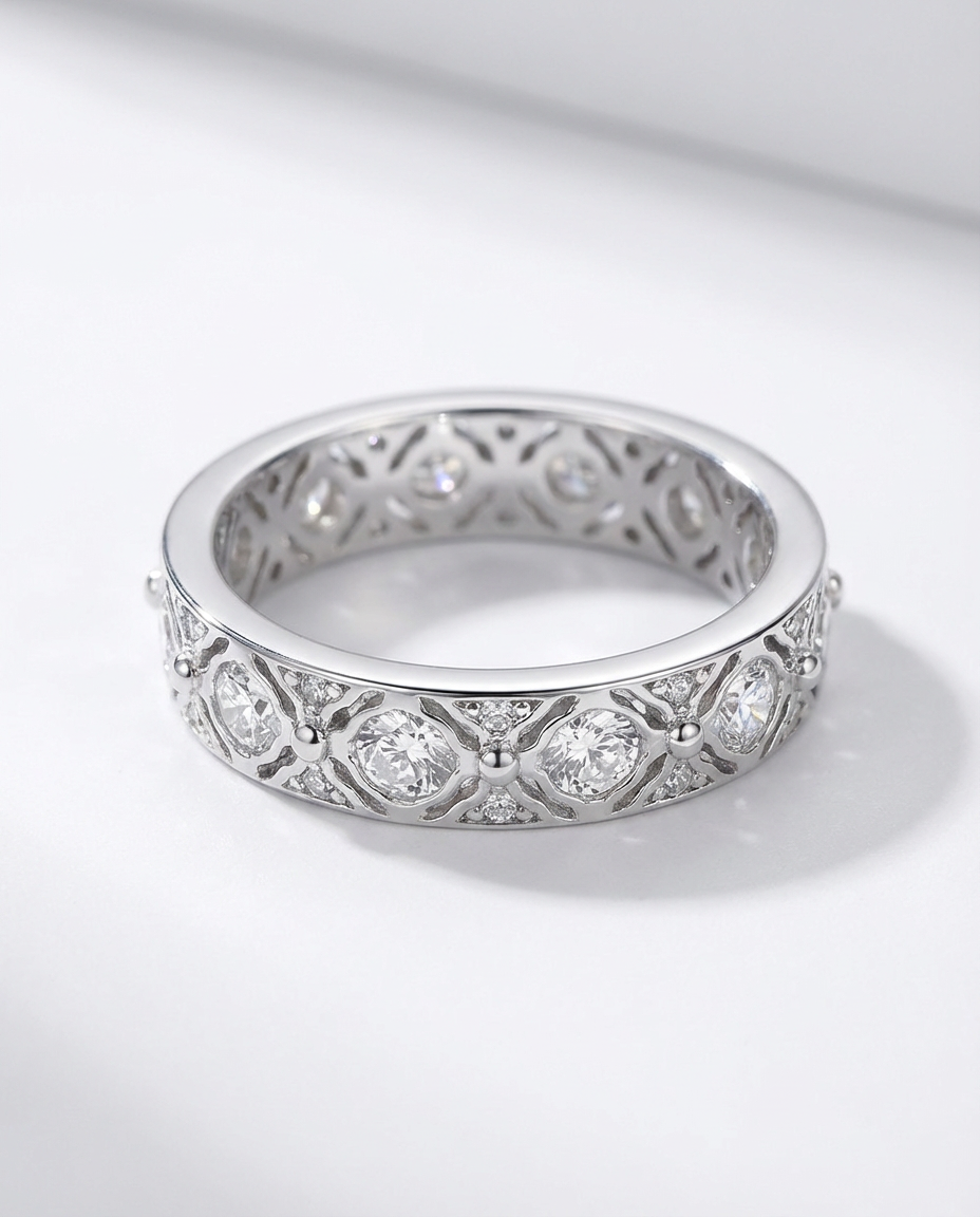 Silver ring with diamond accents on a white background