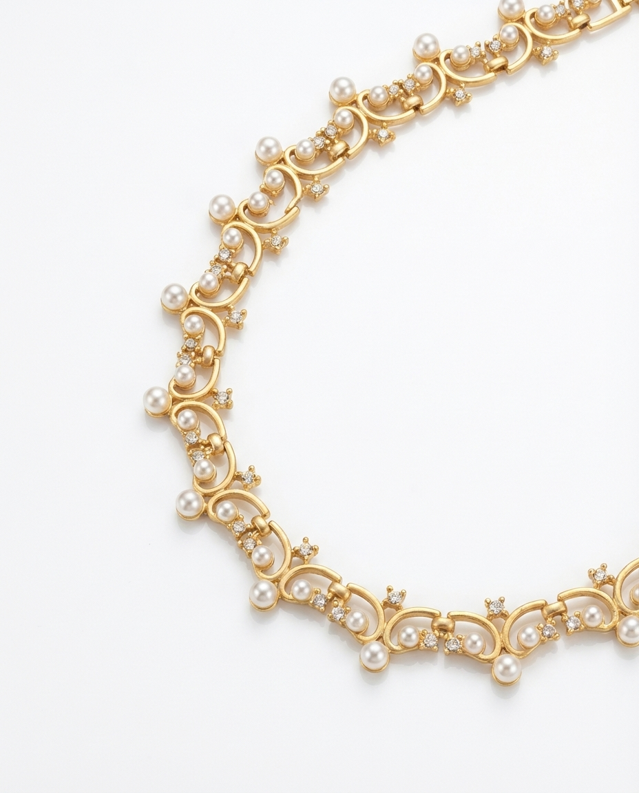 Gold necklace with pearls on a white background