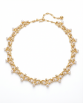Gold necklace with pearls on a white background