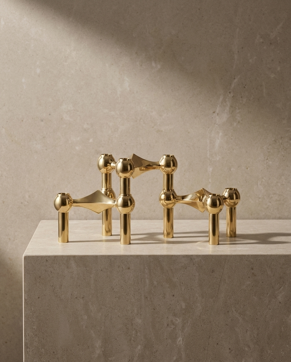 Set of gold decorative pieces on a light stone surface with a neutral background