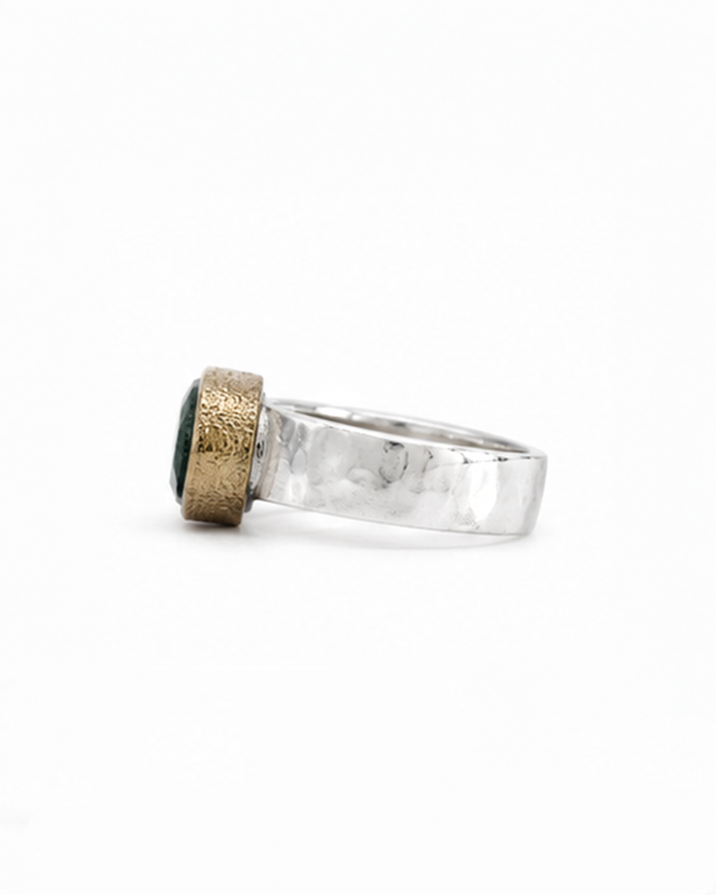 Oval green gemstone signet ring featuring a polished sterling silver band and softly brushed gold bezel. The dark moss green faceted stone sits in a minimalist contemporary setting, photographed against a clean white background.
