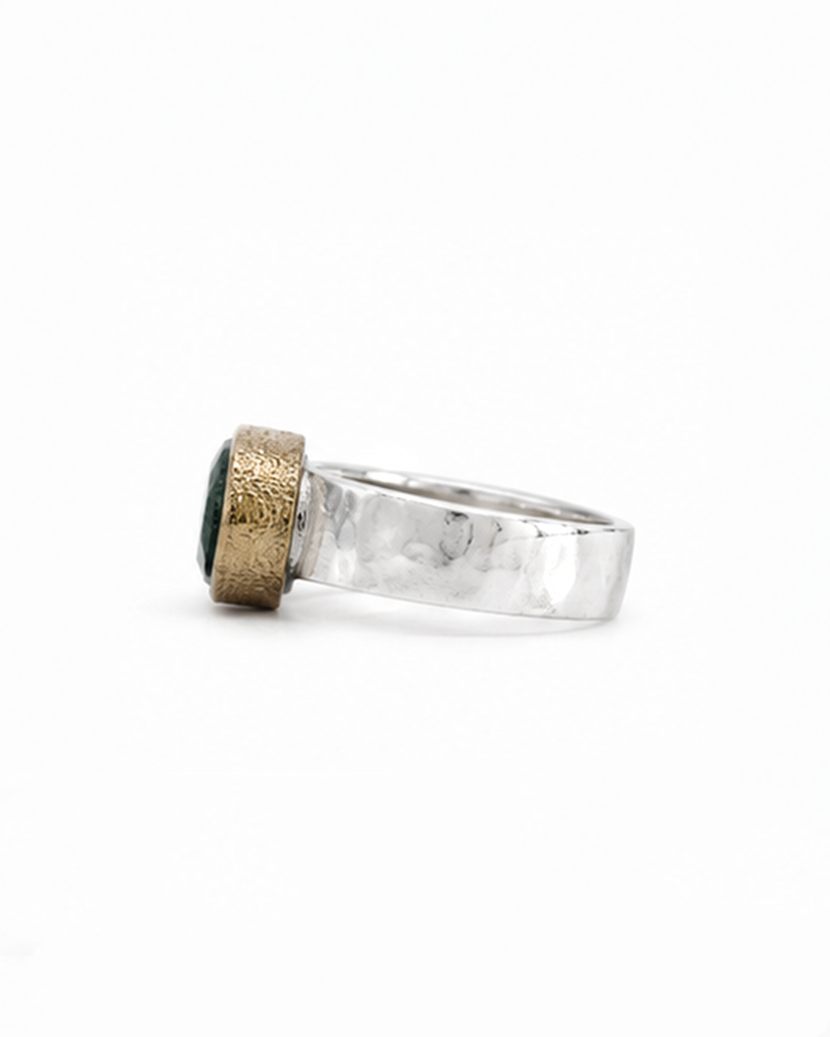 Oval green gemstone signet ring featuring a polished sterling silver band and softly brushed gold bezel. The dark moss green faceted stone sits in a minimalist contemporary setting, photographed against a clean white background.
