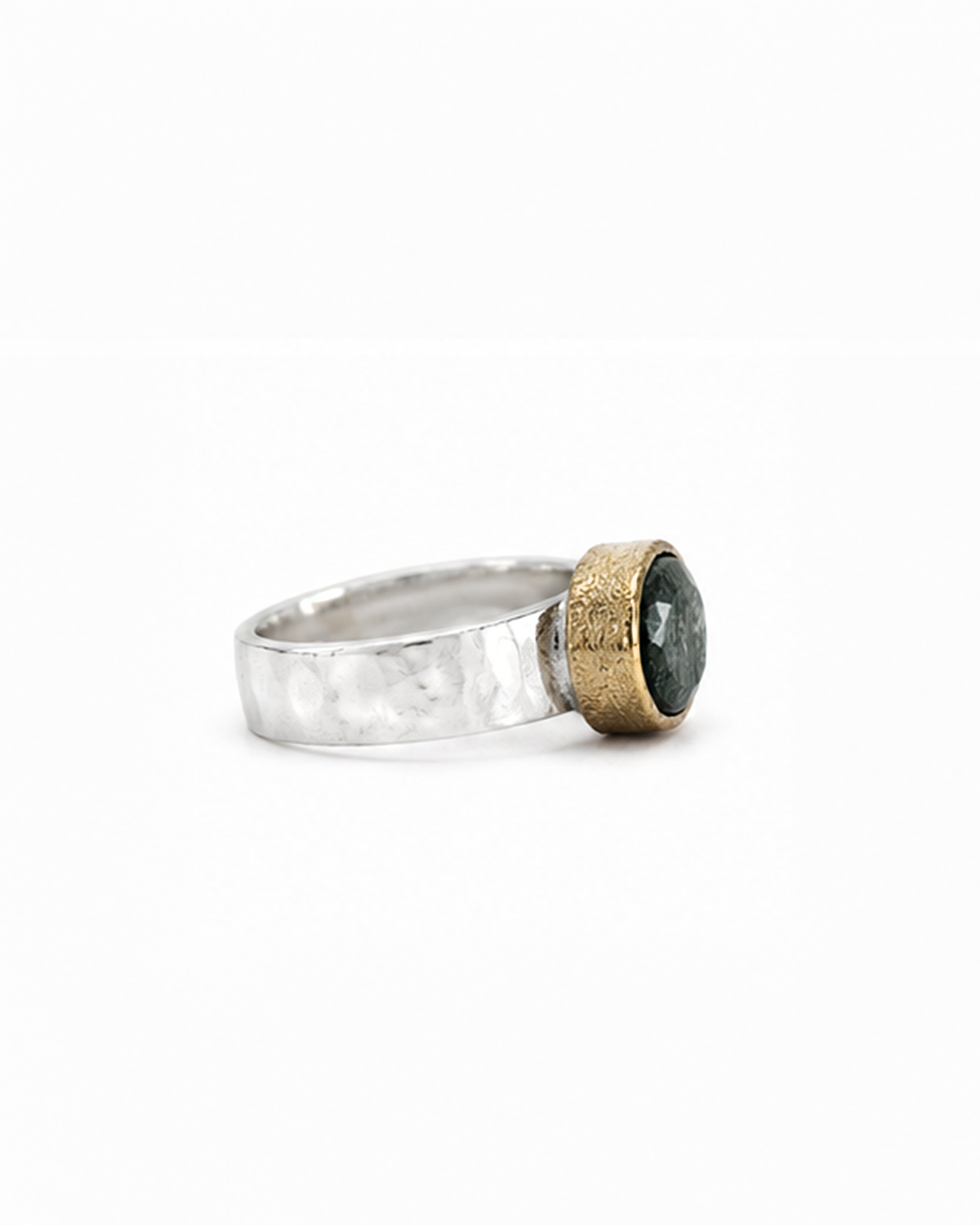 Oval green gemstone signet ring featuring a polished sterling silver band and softly brushed gold bezel. The dark moss green faceted stone sits in a minimalist contemporary setting, photographed against a clean white background.