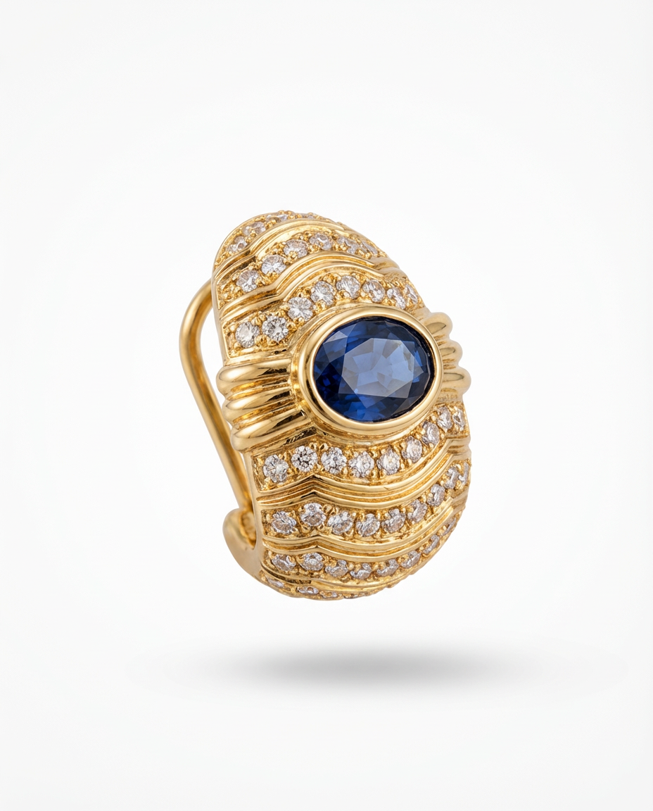 Gold ring with a blue gemstone and diamond accents on a white background