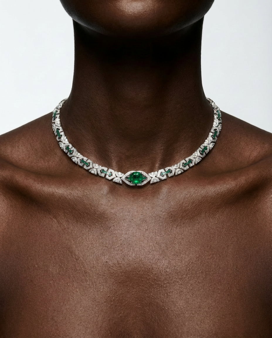 Jewelry necklace with green gemstones on a model against a neutral background