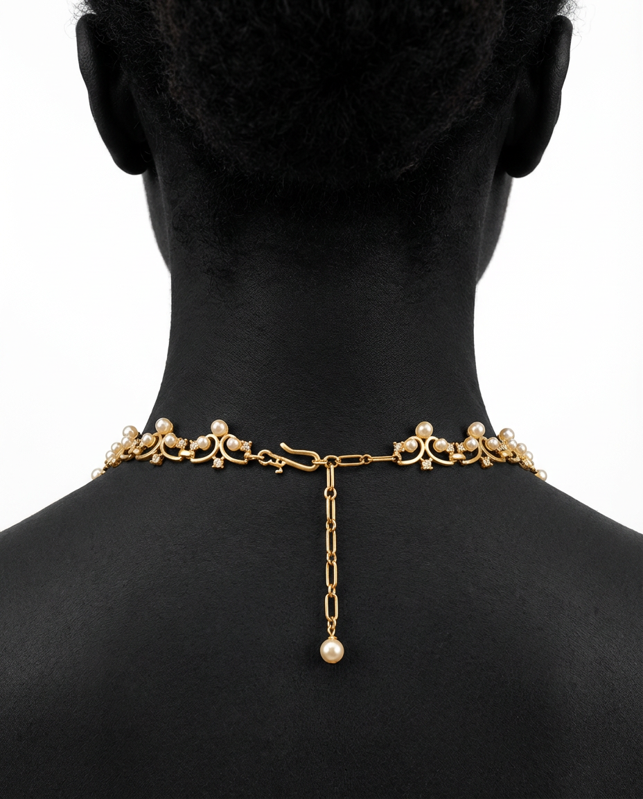 Gold necklace with pearls on a black mannequin