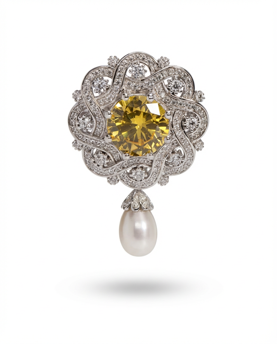 Elegant brooch with yellow gemstone and pearl on a white background