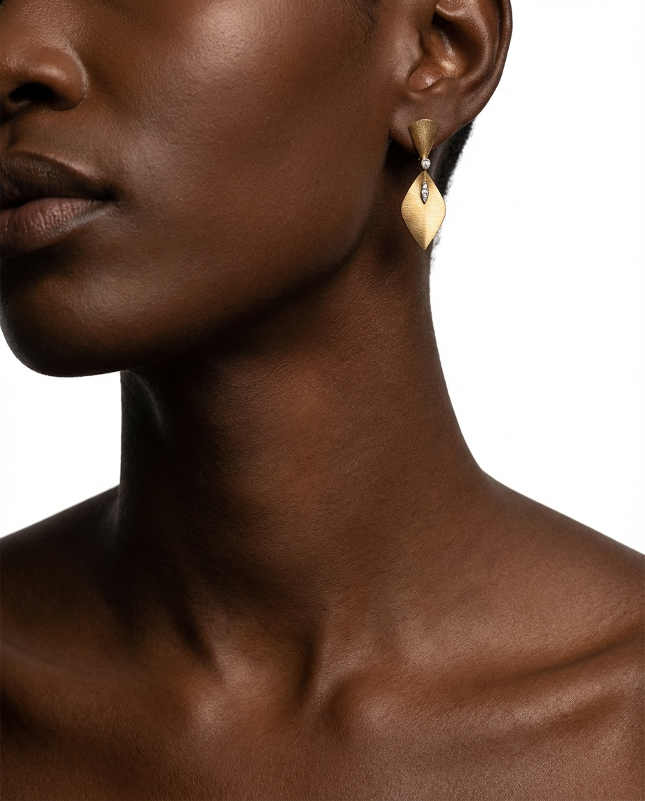 Close-up of a woman wearing gold earrings on a white background