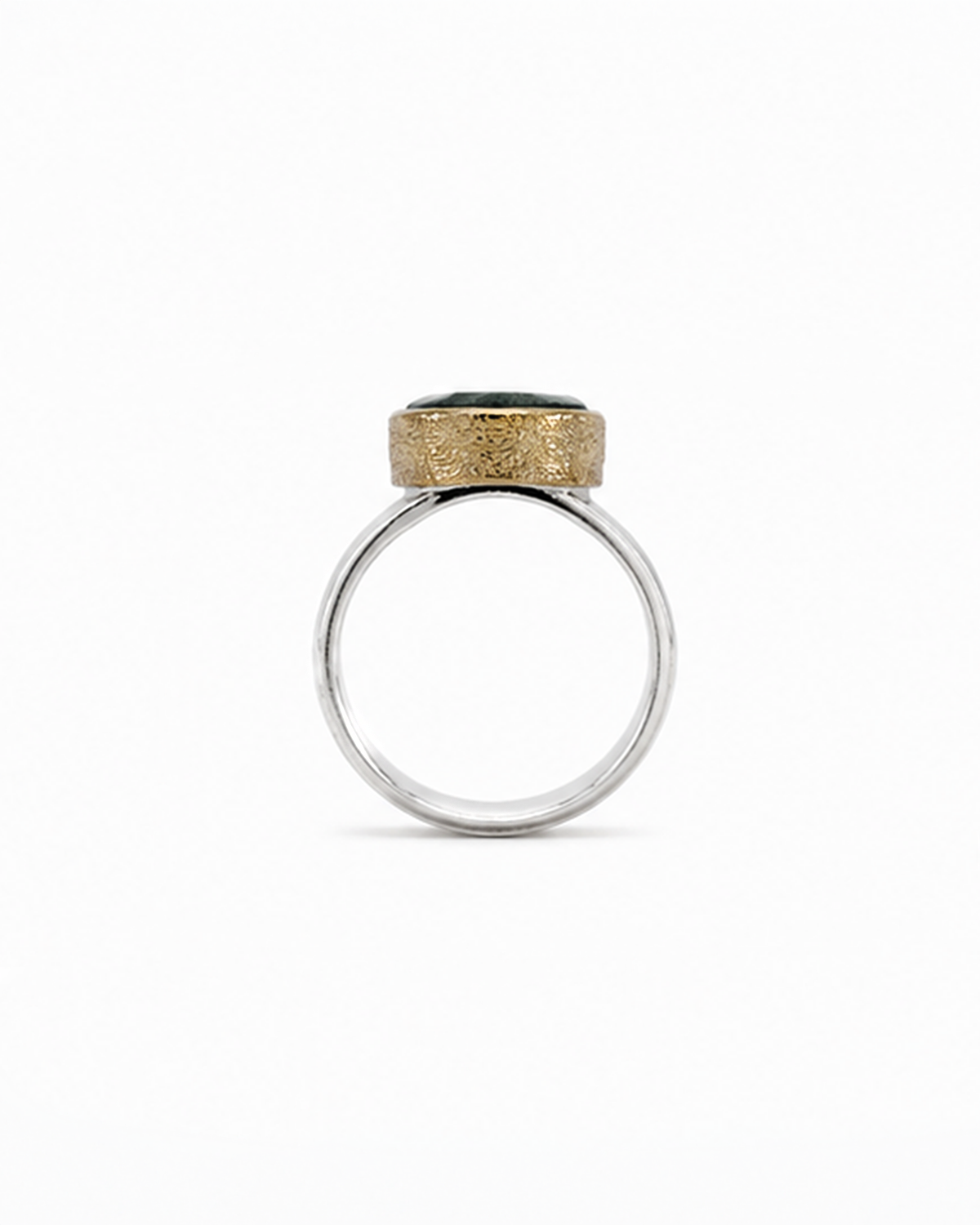 Oval green gemstone signet ring featuring a polished sterling silver band and softly brushed gold bezel. The dark moss green faceted stone sits in a minimalist contemporary setting, photographed against a clean white background.