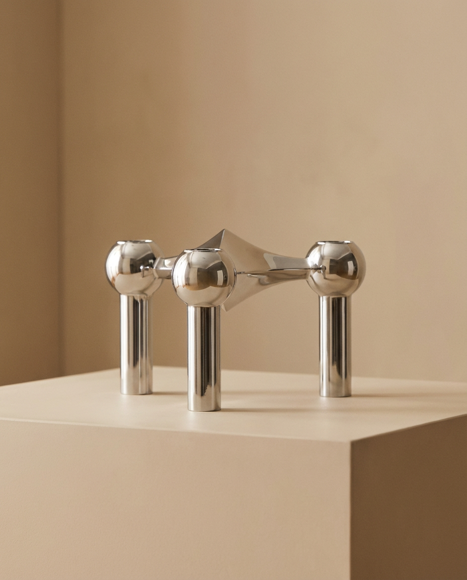 Modern silver faucet on a beige background