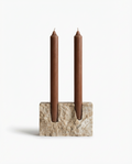 Candle holder with two brown candles on a white background