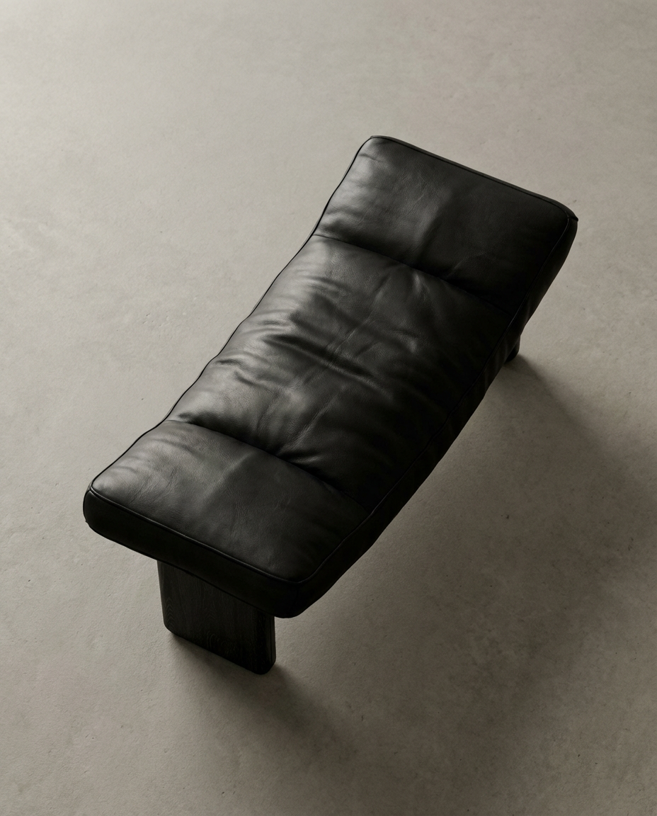 Black leather lounge chair on a gray background