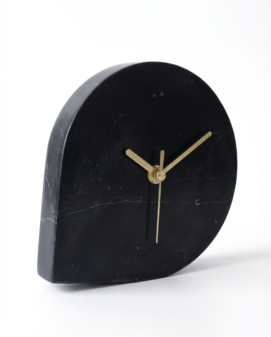 Black marble clock with gold hands on a white background
