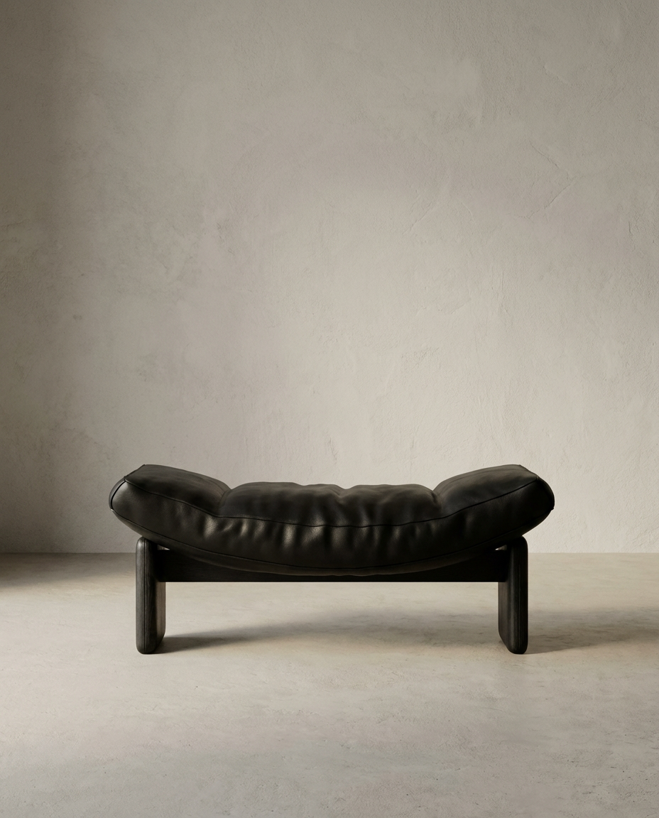 Black leather sofa against a plain wall