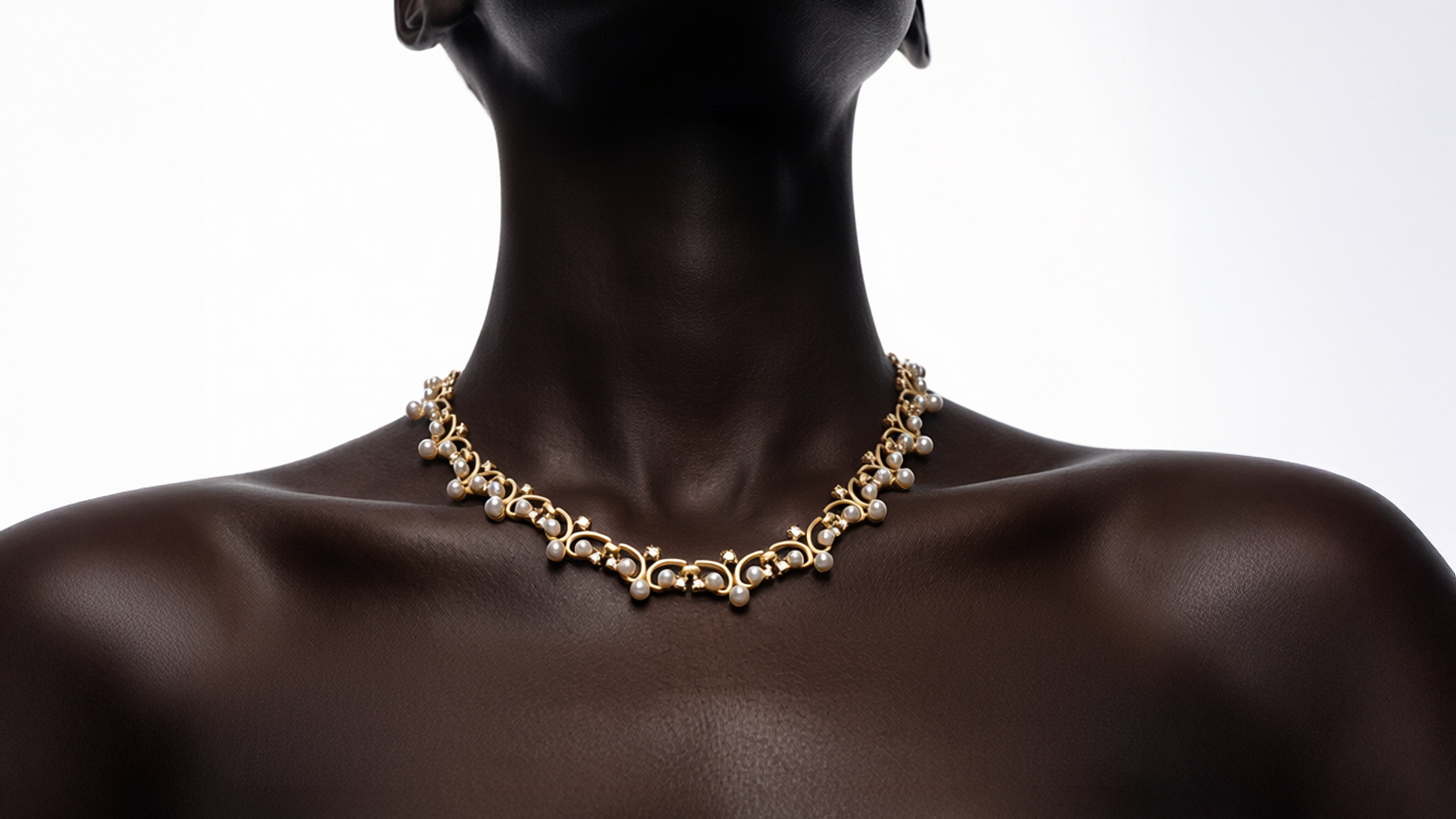 Gold necklace on a mannequin against a white background