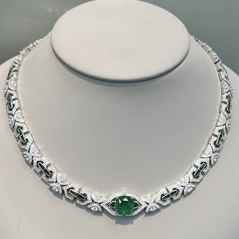 Elegant necklace with green gemstones on a gray background
