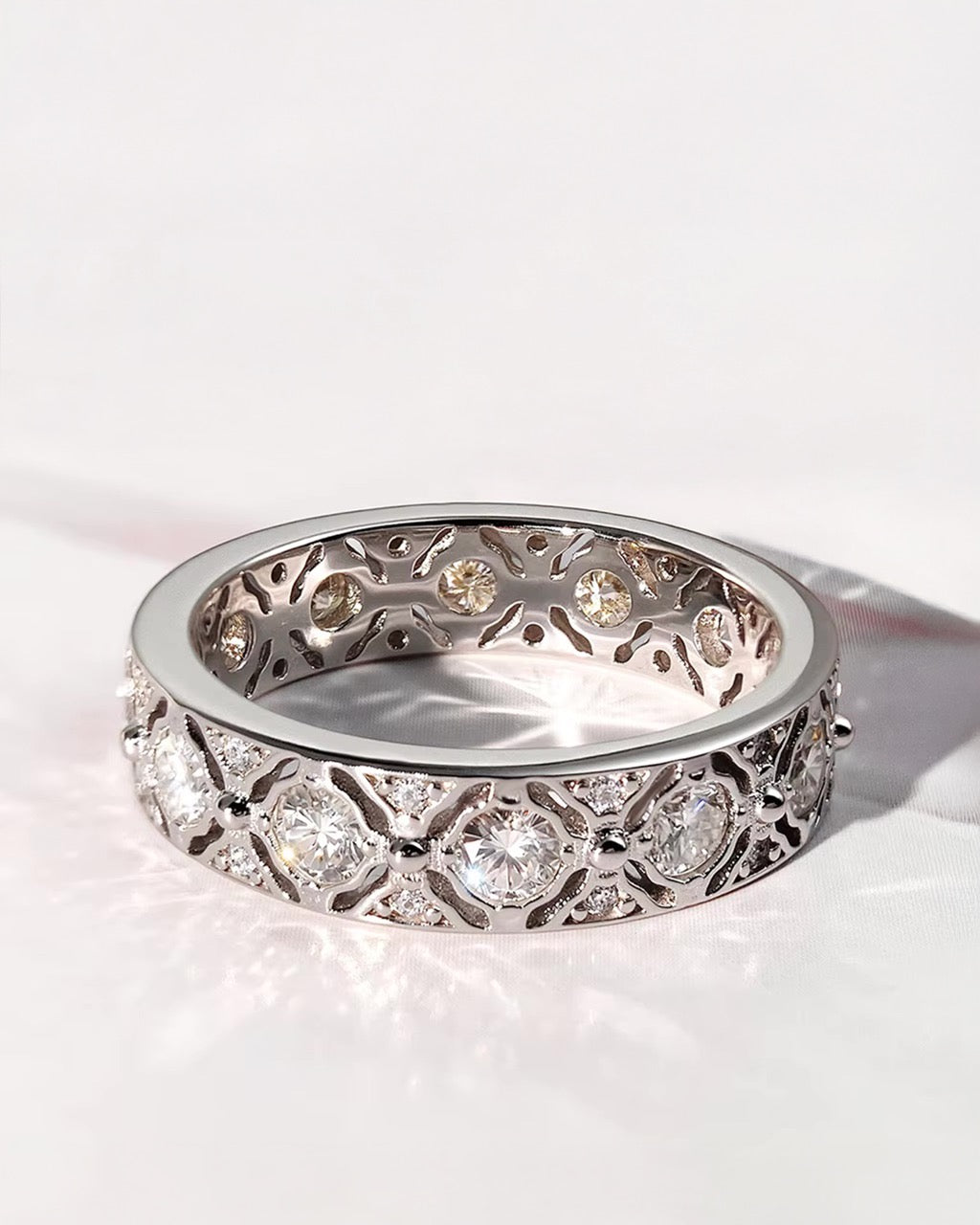 Silver ring with diamond accents on a white background