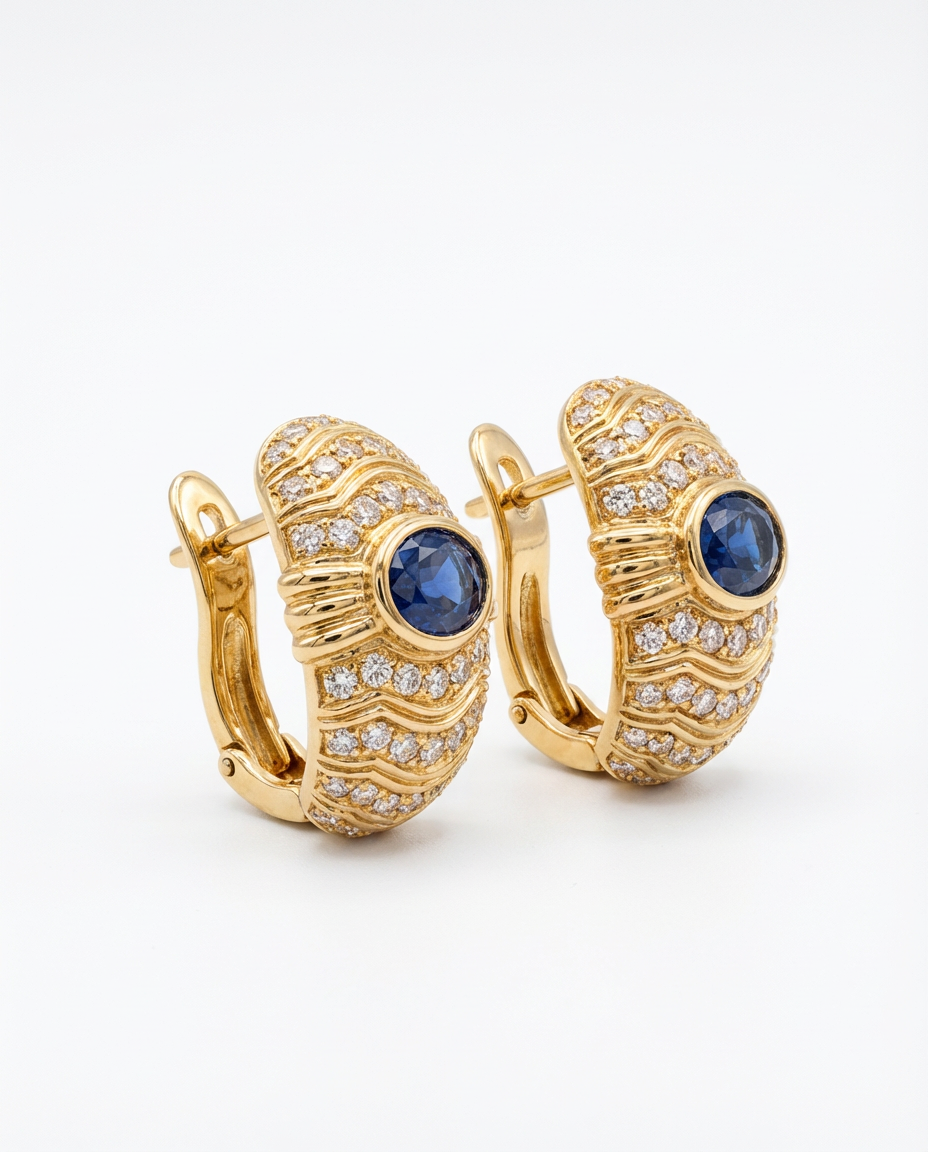 Gold hoop earrings with blue gemstones on a white background