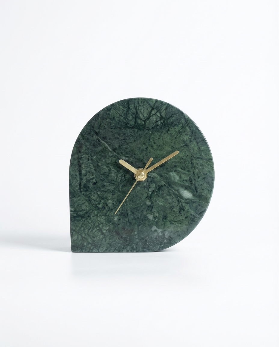 Green marble clock with gold hands on a white background