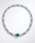 Elegant necklace with emeralds and diamonds on a white background