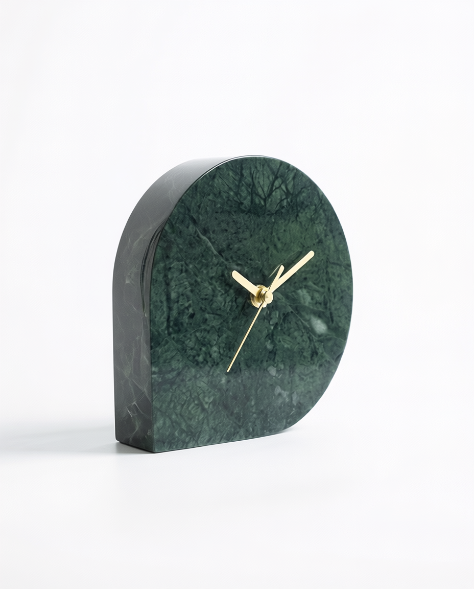 Green marble clock with gold hands on a white background
