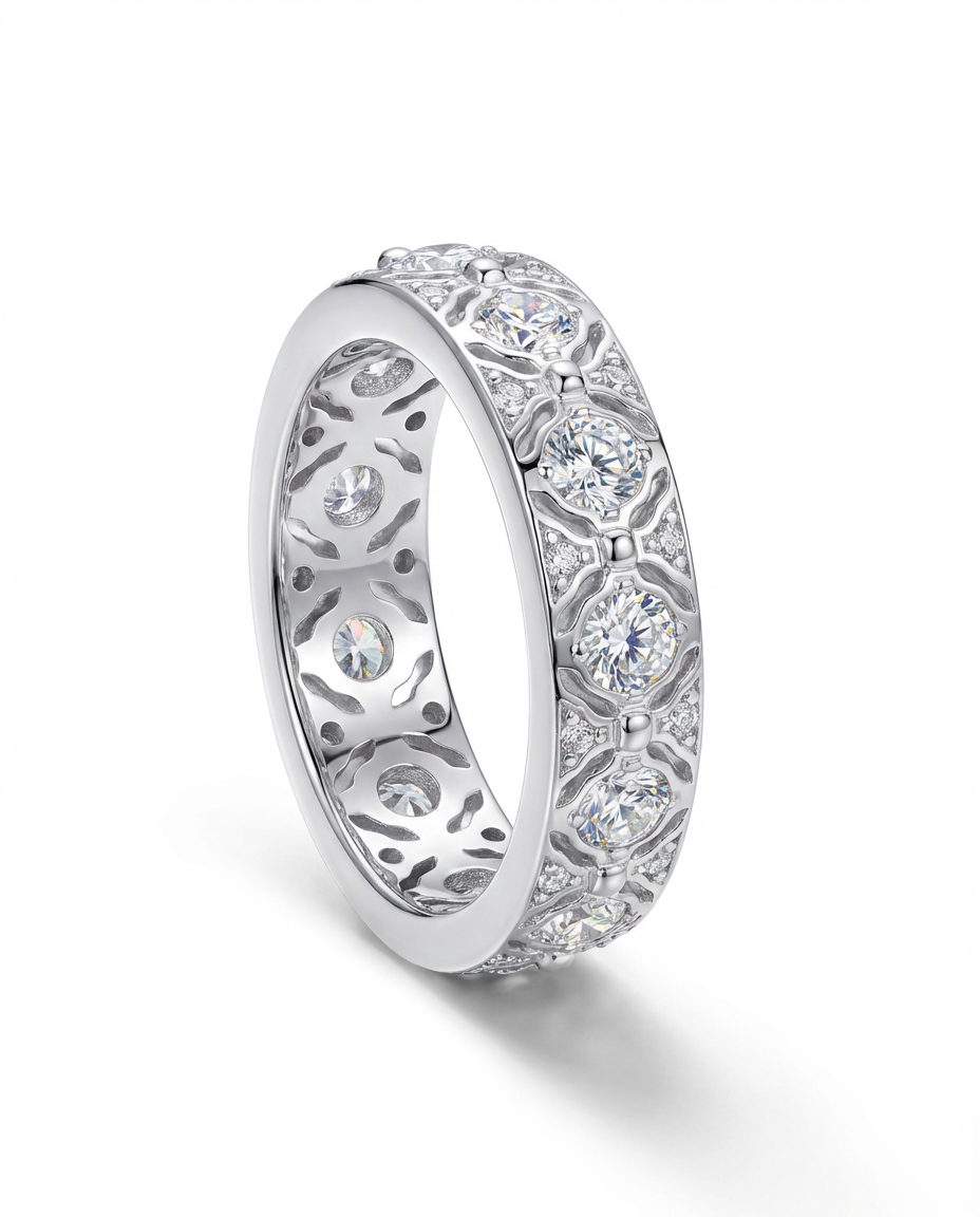 Silver ring with intricate design and embedded diamonds on a white background