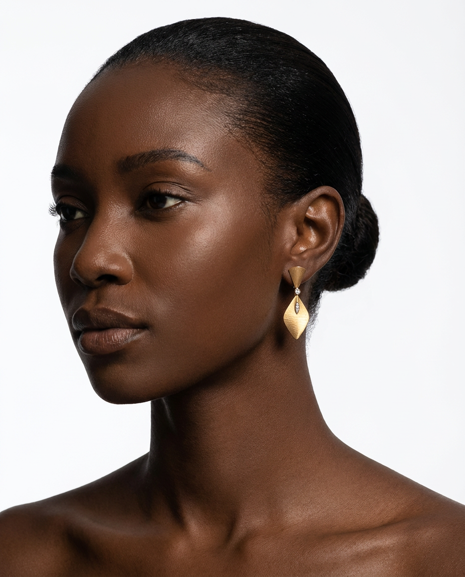 Woman wearing gold earrings against a white background