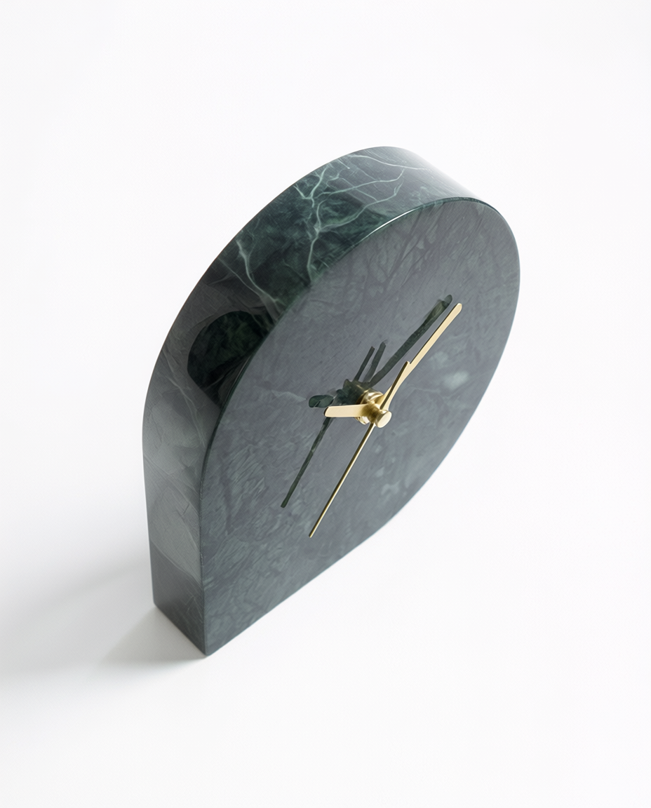 Marble-textured clock with gold hands on a white background