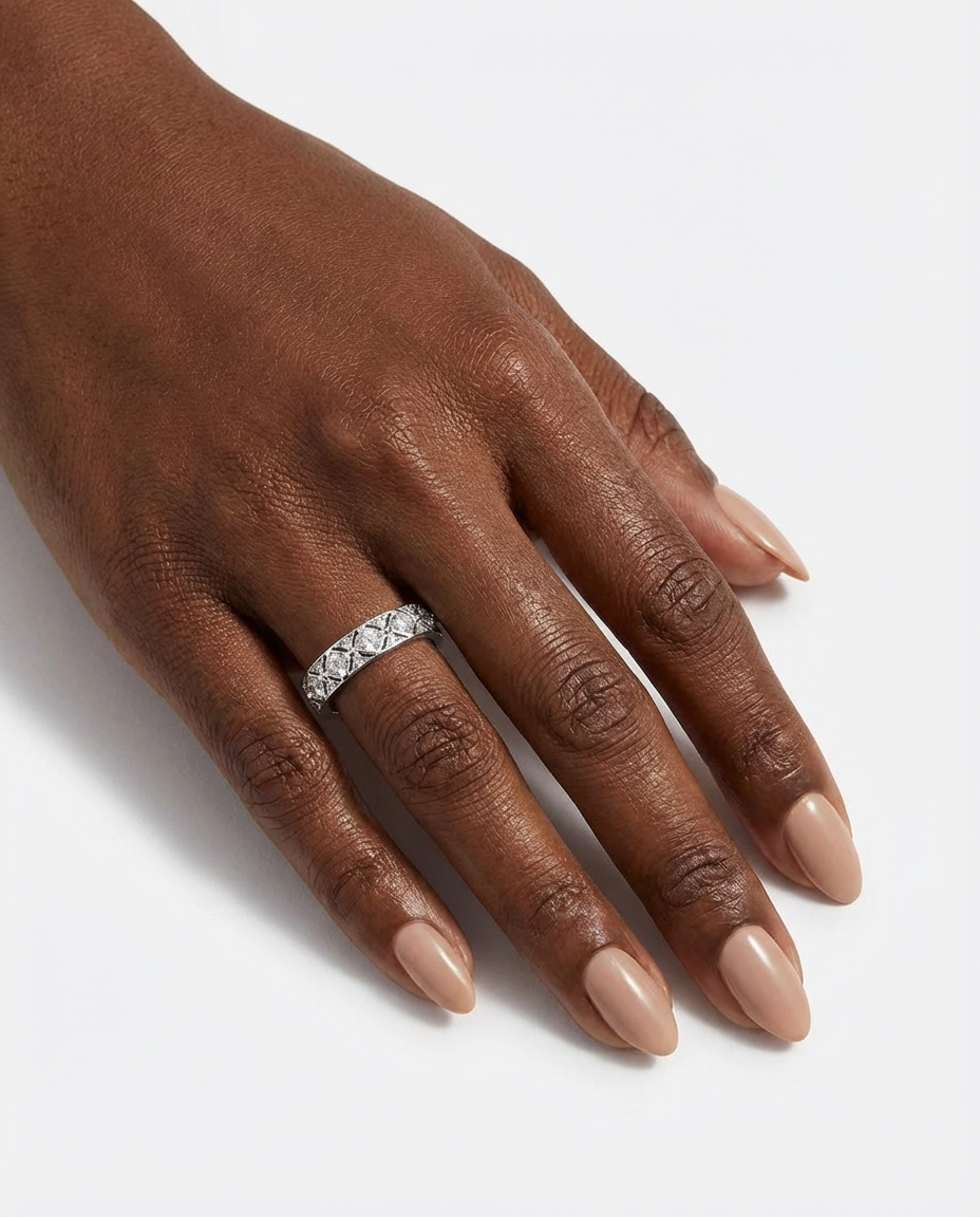 Hand wearing a diamond ring on a light background
