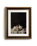 Framed artwork of garlic bulbs on a dark background