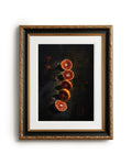 Framed artwork of sliced oranges on a dark background