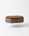 Stool with a brown leather seat and stone-like base on a white background