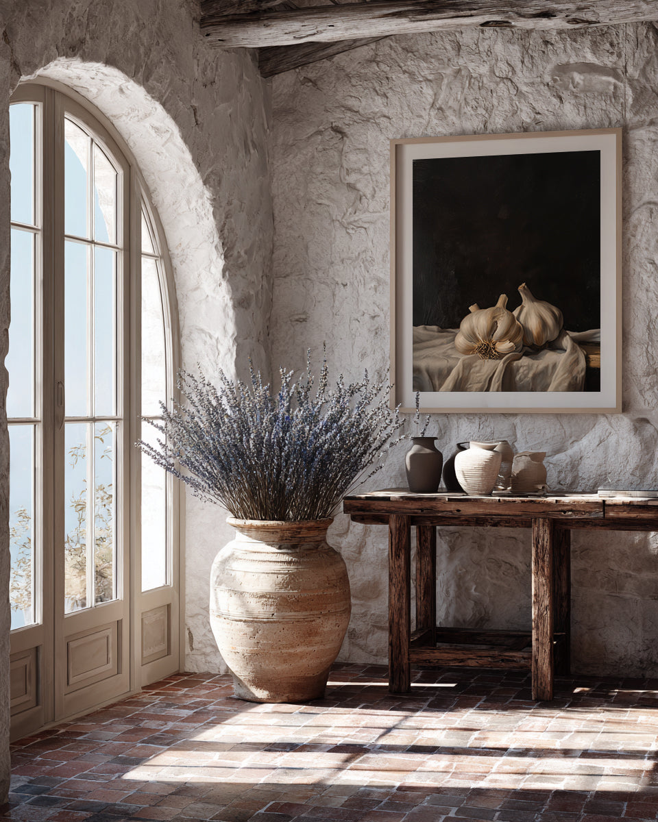 Room with stone walls, large vase with lavender, and framed artwork.
