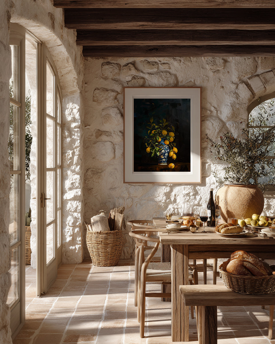 Dining room with stone walls, wooden table, and framed artwork.