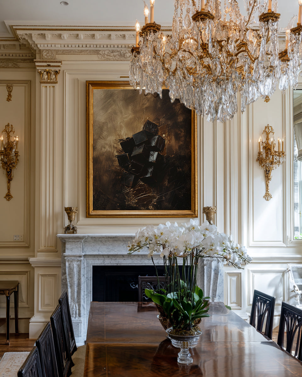 Elegant dining room with a large chandelier, marble fireplace, and artwork.