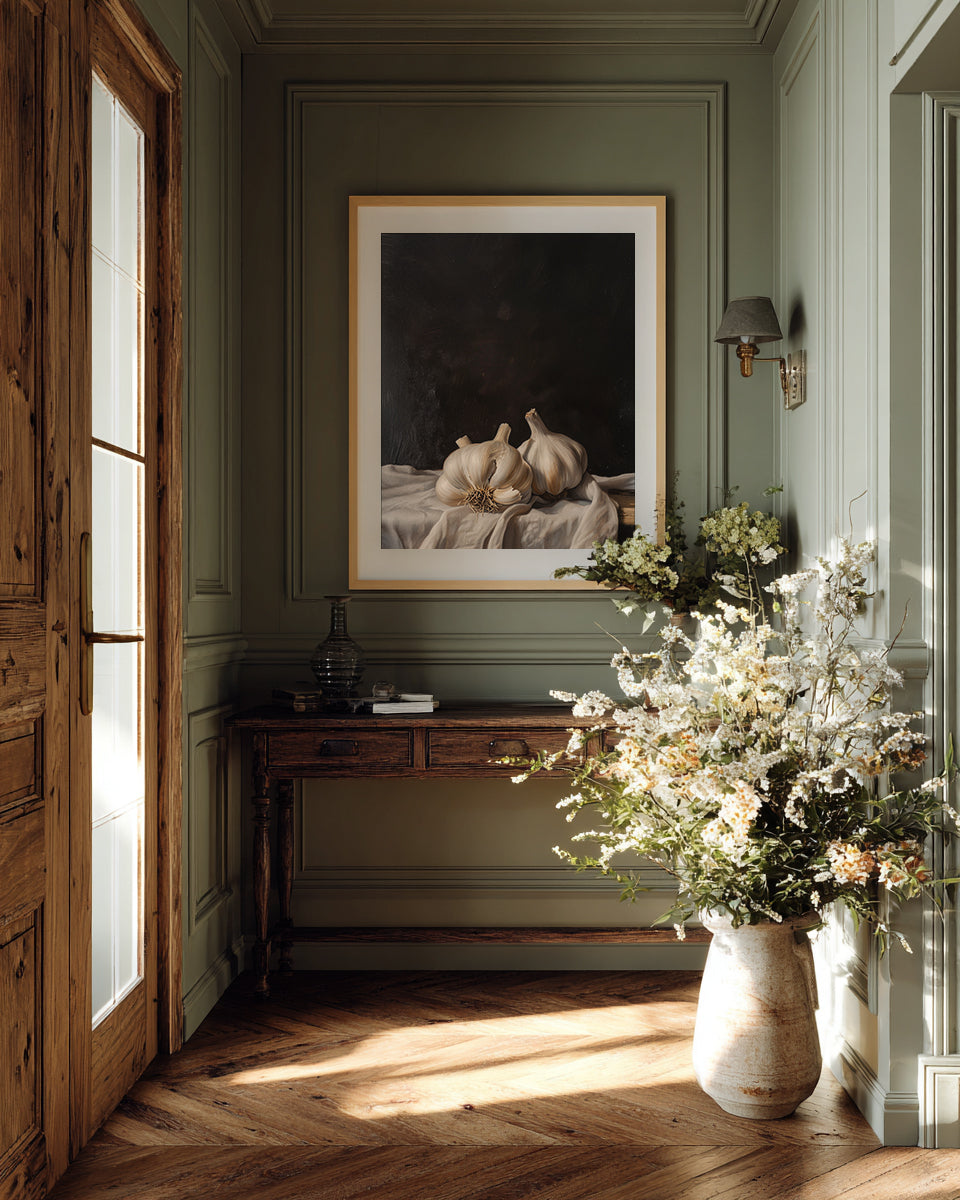 Decorative interior with a vase of flowers, framed artwork, and wooden furniture.