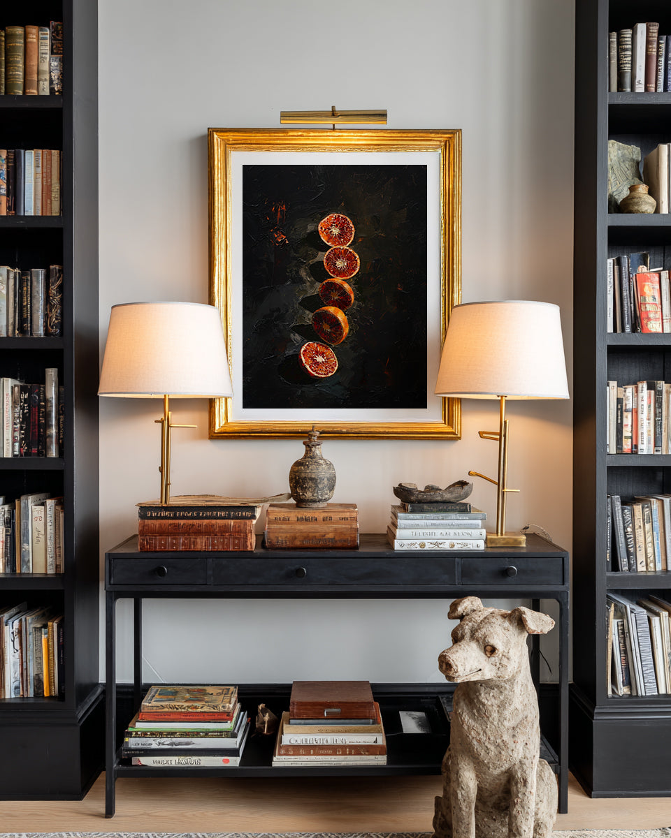 Decorative setup with framed artwork, books, lamps, and a dog statue in a room.