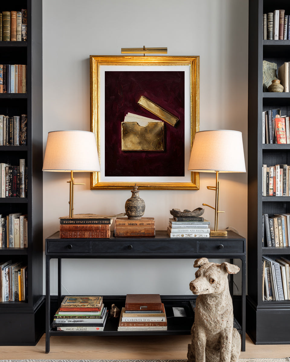 Decorative setup with books, lamps, a framed artwork, and a dog statue in a room.