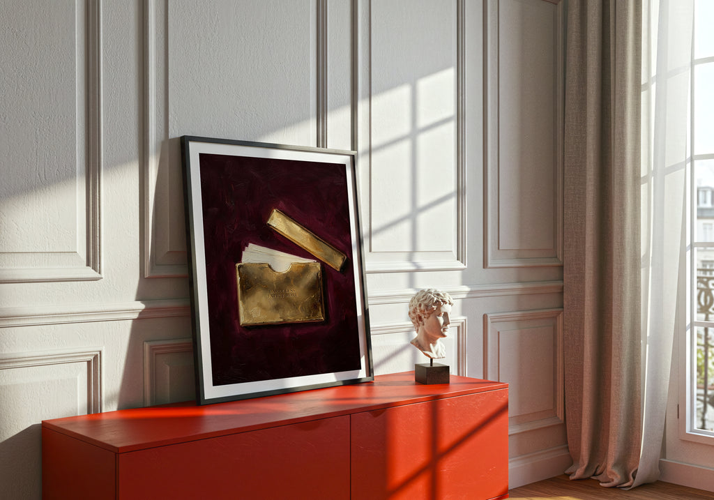 Framed artwork on a red cabinet with a window in the background