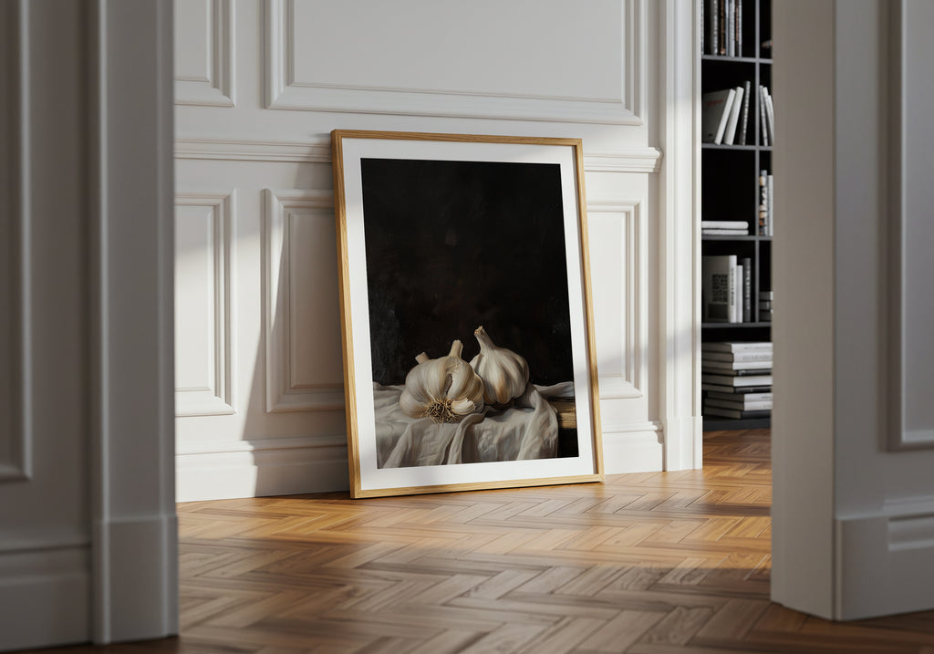 Framed artwork on a wall in a room with wooden flooring and a bookshelf.