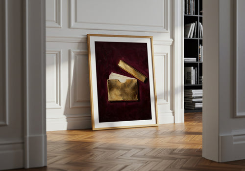 Framed artwork on a wall in a room with wooden flooring and bookshelf.