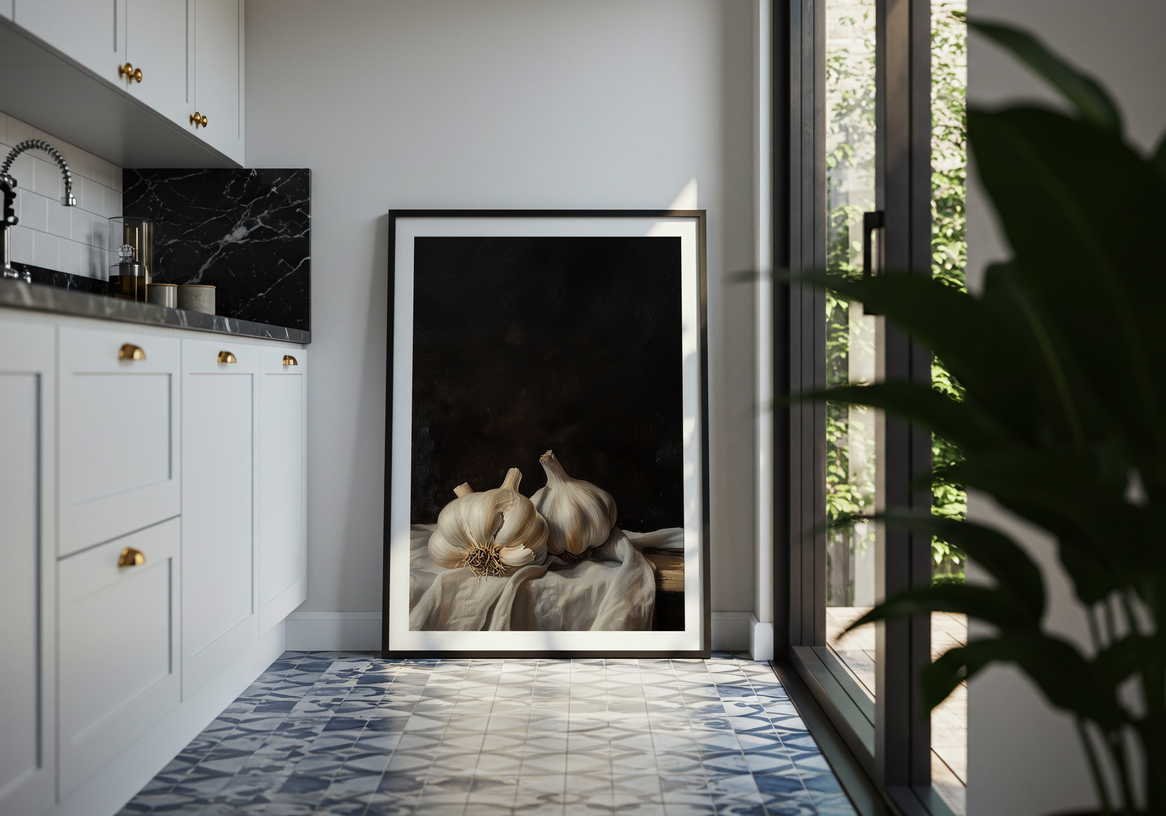 Framed artwork in a modern kitchen with white cabinets and a tiled floor.