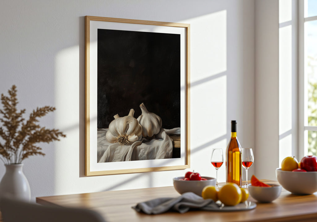 Framed artwork of garlic bulbs on a table with wine and fruit